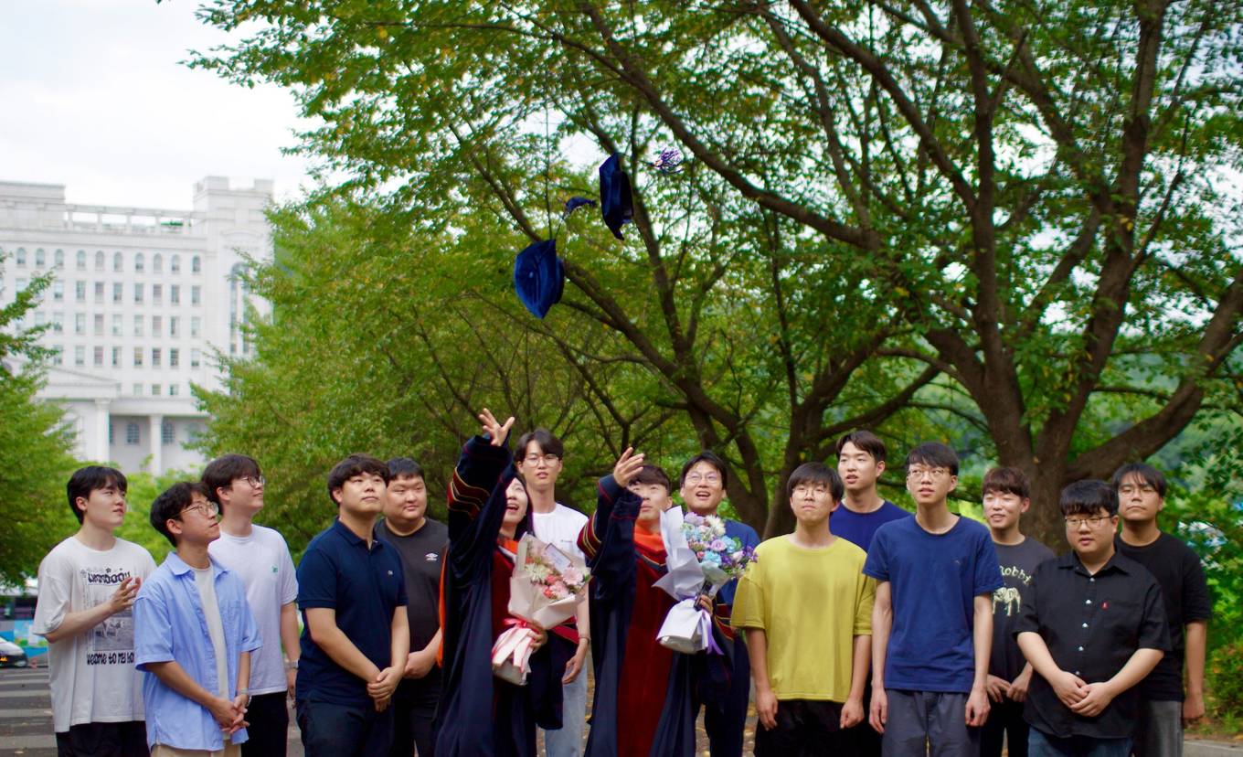 AIR Lab members tossing graduation caps